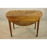 A 19th century mahogany Pembroke table raised on square tapering supports terminating in brass