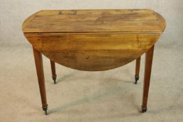 A 19th century mahogany Pembroke table raised on square tapering supports terminating in brass