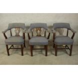 A set of three 20th century mahogany framed open arm and pierced splat back chairs raised on