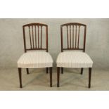 A pair of 19th century Sheraton style mahogany framed dining chairs with cream upholstered stuffover