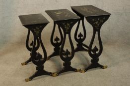 A nest of three early 20th century lacquered intersliding occasional tables with floral