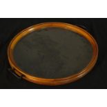 A mid 20th century teak framed and glass twin handled circular tray. Dia.42cm.