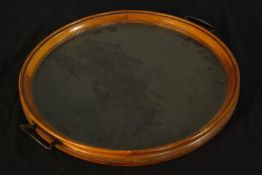 A mid 20th century teak framed and glass twin handled circular tray. Dia.42cm.