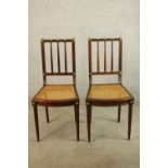 A pair of 19th/early 20th century cane seated and bar backed bedroom chairs each raised on turned
