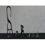 A set of three contemporary African brass figures raised on hardstone bases, together with a