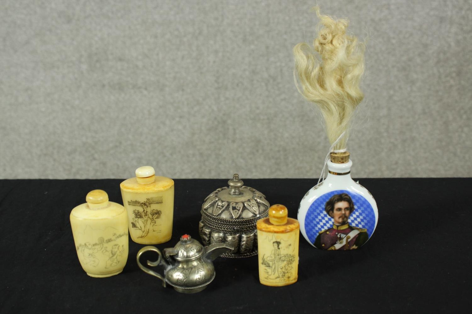 Three 20th century Chinese bone snuff bottles and stoppers, together with a small white metal Indian
