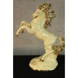 A 20th century Italian La Fiamma glazed pottery model of a rearing horse, marks to base. H.51cm.