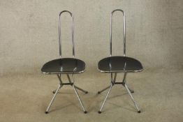 A pair of late 20th century black plexi and chrome framed folding chairs by Niels Gammelgaard for