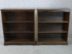A pair of stained three shelf open bookshelves raised on shaped bracket feet. H.98 W.85 D.30cm