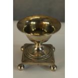 An early 19th century French silver campagna shaped table salt on stepped square base raised on four