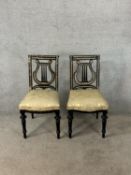 A pair of 19th century ebonised and mother of pearl inset chairs with stuffover seats raised on