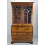 A 19th century mahogany twin glazed door secretaire bookcase opening to reveal adjustable shelves