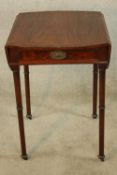 A George III mahogany Pembroke table raised on turned supports terminating in casters. H.72 W.94 (