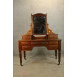 A late 19th/early 20th century walnut mirror backed dressing table with two jewellery drawers