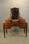 A late 19th/early 20th century walnut mirror backed dressing table with two jewellery drawers