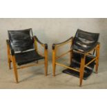 A pair of mid 20th century oak and black leather Aage Bruun & Son Safari chairs, each raised on