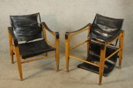 A pair of mid 20th century oak and black leather Aage Bruun & Son Safari chairs, each raised on