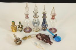A quantity of vintage glass and gilt decorated miniature perfume bottles and stoppers. H.8cm. (