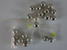 A collection of twenty one round polished white metal beads (tests as silver), various sizes. H.2