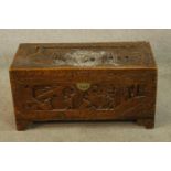 A late 19th/early 20th century carved Chinese camphorwood blanket chest raised on shaped bracket