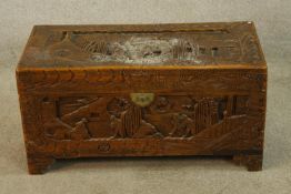 A late 19th/early 20th century carved Chinese camphorwood blanket chest raised on shaped bracket