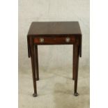 A 19th century small mahogany dropleaf table with single drawer, brass swing handles raised on