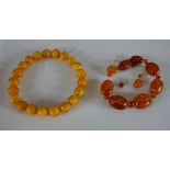 Two strings of amber beads, including a string of large amber beads (measuring 3cm) and smaller