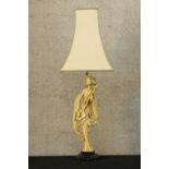 A 20th century composite figural table lamp moulded in the form of a Chinese lady raised on