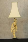 A 20th century composite figural table lamp moulded in the form of a Chinese lady raised on
