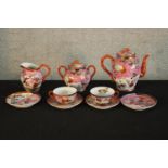 A 20th century Chinese porcelain part teaset with floral decoration, bearing Chinese character marks