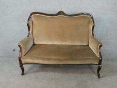 An early 20th century French mahogany framed two seater settee raised on carved cabriole supports.