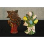 Two contemporary painted cast iron doorstops, one in the form of a bouquet of flowers, the other