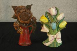 Two contemporary painted cast iron doorstops, one in the form of a bouquet of flowers, the other