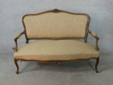 A 19th century French Louis XV style mahogany framed open arm settee raised on carved cabriole