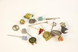 A collection of Danish silver, brass and white metal badges, buttons and pins.