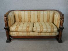 A 19th century, possibly Scandinavian, mahogany bow back two seater settee, the arms carved with