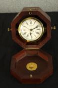 A 20th century brass and glass cased nautical style clock bearing the name Bulova, the white dial
