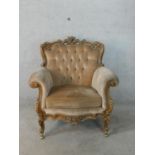 A 19th French carved beech framed button back scroll armchair raised on carved supports