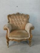 A 19th French carved beech framed button back scroll armchair raised on carved supports