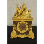 A 19th century French marble and ormolu mounted mantle clock surmounted with a young child and