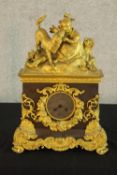 A 19th century French marble and ormolu mounted mantle clock surmounted with a young child and