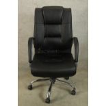 A contemporary black upholstered and chrome framed open arm adjustable office chair raised five