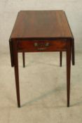 A George III mahogany rectangular drop flap Pembroke table with single drawer raised on tapering