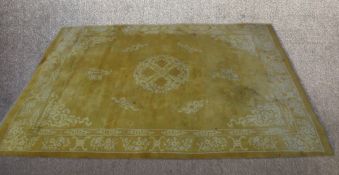 A contemporary large Chinese yellow ground carpet embroidered with floral decoration. L.365 W.265cm.