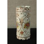 A contemporary Portuguese tin glazed faience cylindrical stick stand decorated with sprays of