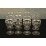 A set of twelve early 20th century wine glasses with acid etched decoration. H.12cm. (each)
