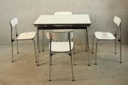 A mid 20th century designer Formica and chrome plated drawleaf extending dining table together