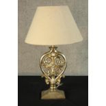 A contemporary Italian silver painted carved and pierced hardwood table lamp raised on rectangular