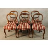 A set of six Victorian mahogany framed balloon back dining chairs with red and white stuff over