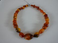 A large string of graduated amber beads, the largest bead measures 3.8cm. L.48cm.